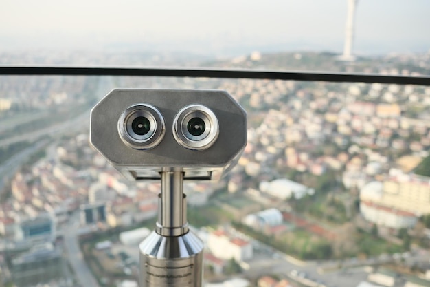 Coinoperated binoculars looking out over city