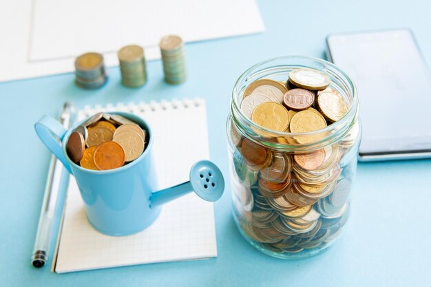 The coins are stored in a glass jar to accumulate finances.