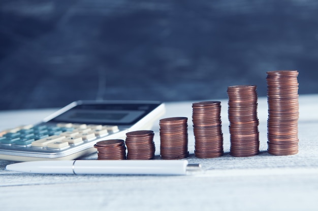 Coins, bills and a calculator on the table