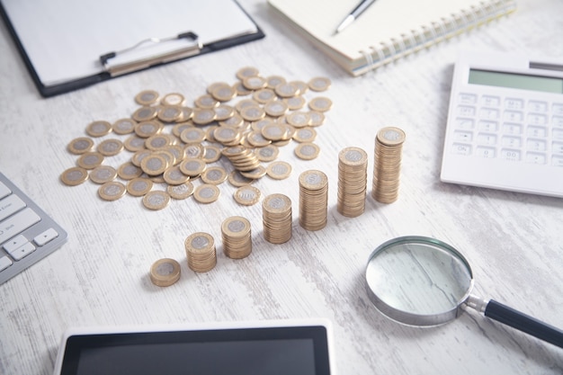 Coins, calculator and other objects on the business desk.