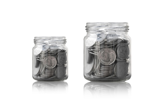 Coins in a glass jar against ,savings coins - Investment And Interest Concept saving money concept, growing money on piggy bank. isolated on white background