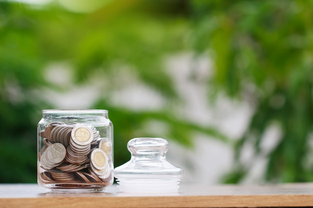 Coins in glass jar for saving money concept