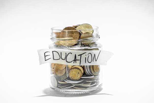 Coins in glass jar with education label Financial concept