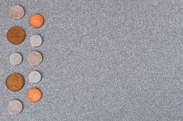 Coins of Great Britain on a background of gray granite.