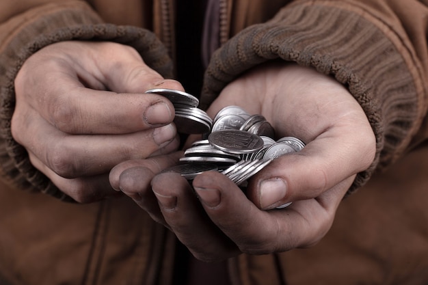 Coins in the hands of a beggar,good man gives alms to the poor.