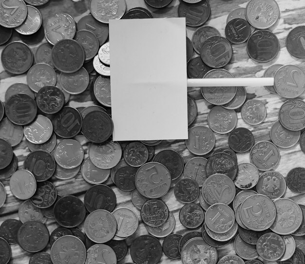 Coins in a jar on the floor. Accumulated coins on the floor. Pocket savings in piles.