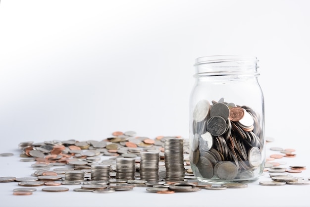 coins in jar with money stack step growing growth saving money, Concept finance business investment