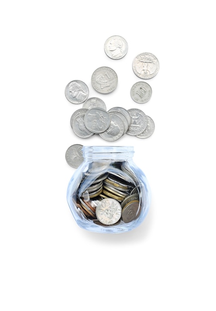 Coins in money glass jar and overflow isolated on white