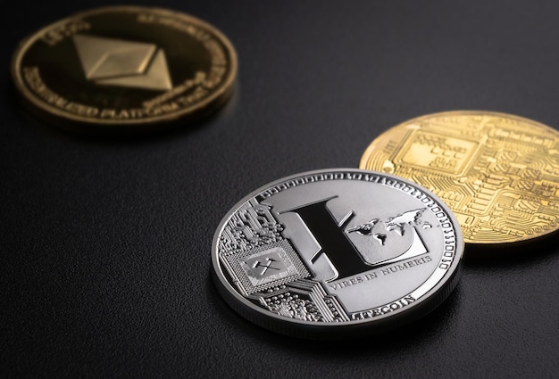 The coins of the most popular cryptocurrencies are on a dark background