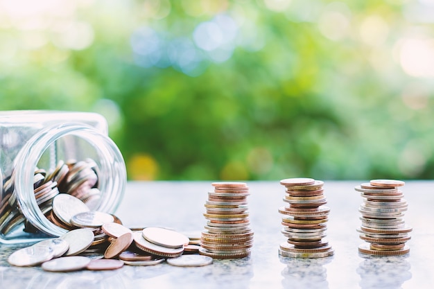 Coins in and outside the glass jar