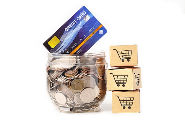 Coins in plastic bottle with credit card model and shopping cart boxs.