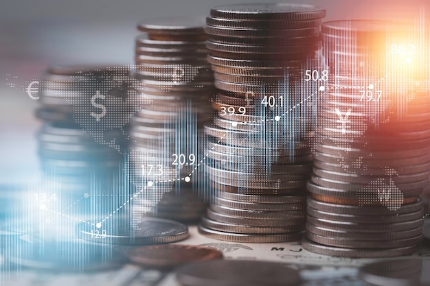 Coins stacking with stock market graph chart for business\
investment and stock market analysis concept