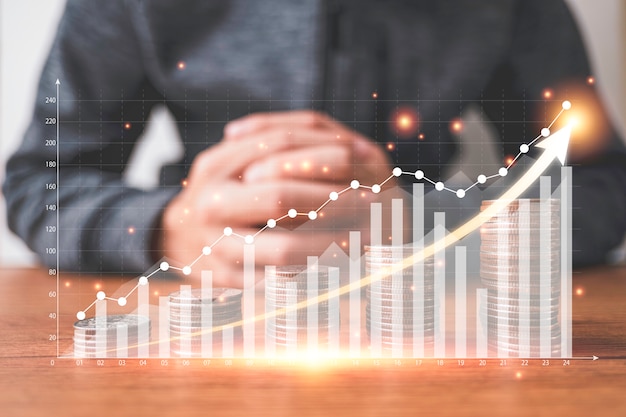 Photo coins stacking with virtual graph and increase arrow in front of businessman. business investment and saving profit concept.