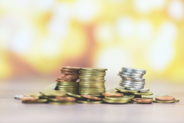 Coins on table - Pile of Golden coin, silver coin and copper coin on wooden money financial concept