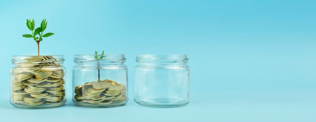 Coins in a transparent jar on a blue background