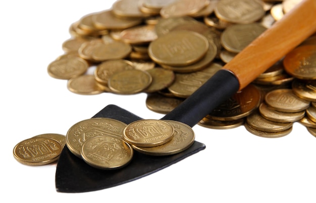 Coins with shovel isolated on white