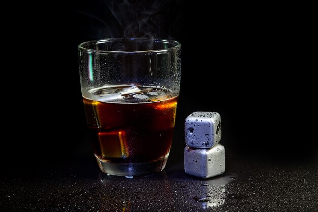 Cold americano decoration with stainless steel cubes ice  on a black table.