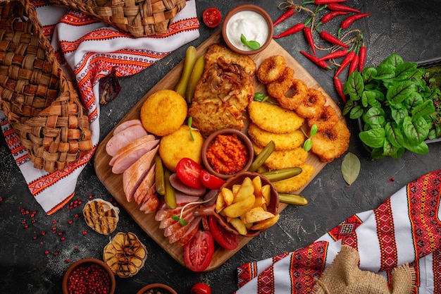 Cold appetizers and charcuterie snacks on a wooden board