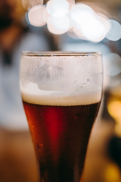 Cold beer glass on bar or pub desk 