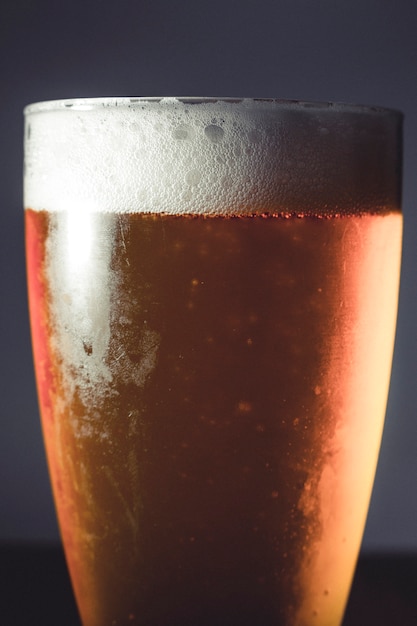 Cold beer glass on a dark background on wooden table