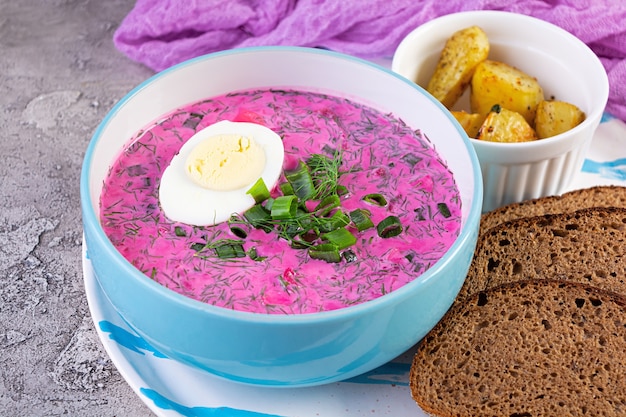 Cold borscht on wooden background. Cold beet soup