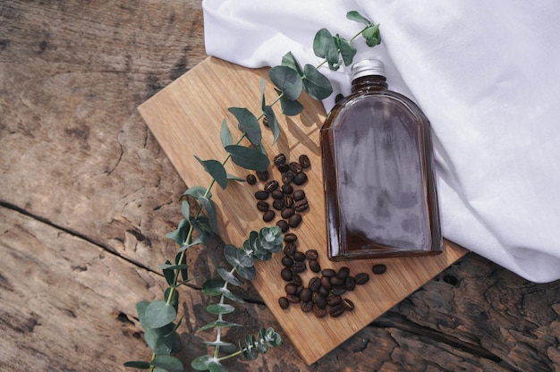 Cold brew coffee bottle mockup and coffee beans on a wooden table packaging mockup