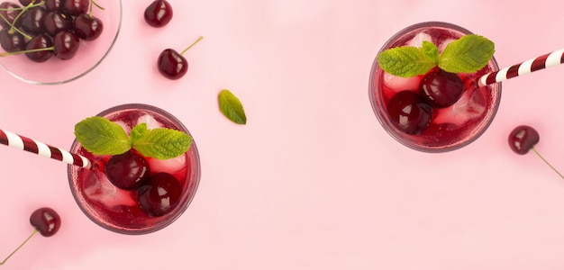 Photo cold cherry lemonade on the pink background top view copy space