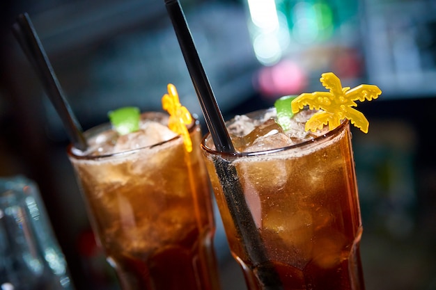 Cold cocktail on a dark blurred background with bokeh.