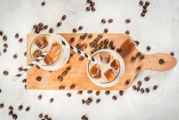 Cold coffee with milk, caramel and ice, with cubes of frozen coffee