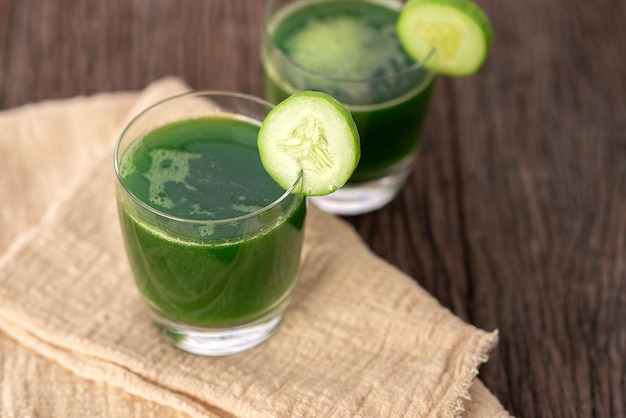 Cold cucumber soup with avocado and mint,Glass of cucumber juice on grey wooden background