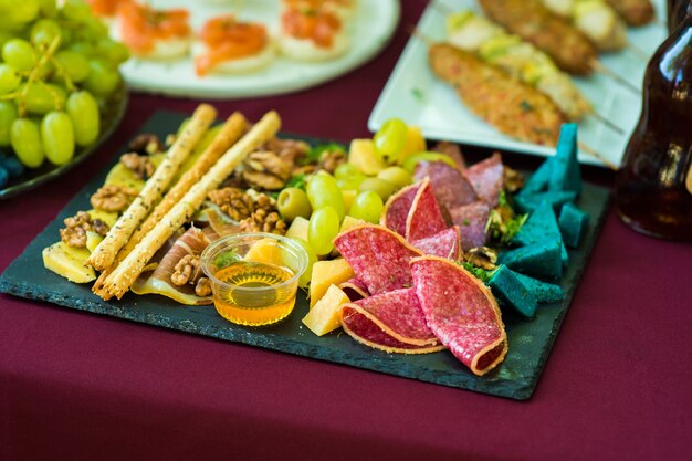 Cold cuts with nuts and honey buffet table