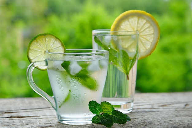 A cold drink made of lemon, lime and mint outdors