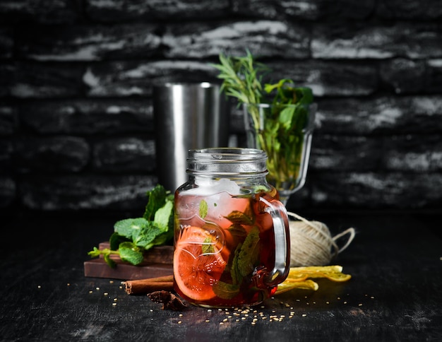 Cold drink with lemon mint in a glass cup On a wooden background