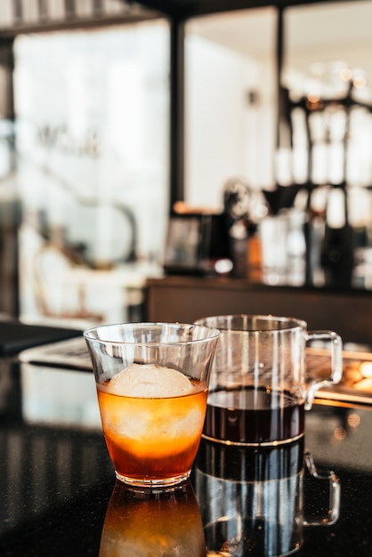 cold drip arabica black coffee in glass with ice ball