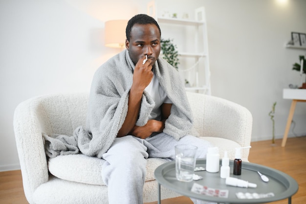 Cold And Flu Treatment Sick African American Man Using Nasal Spray