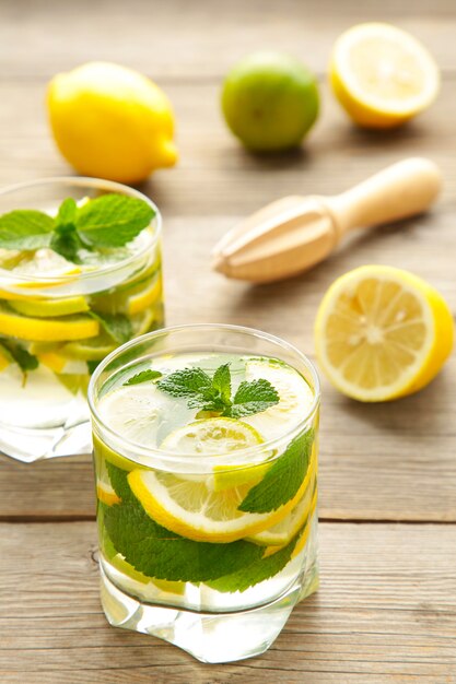 Cold fresh lemonade drink on a grey wooden background