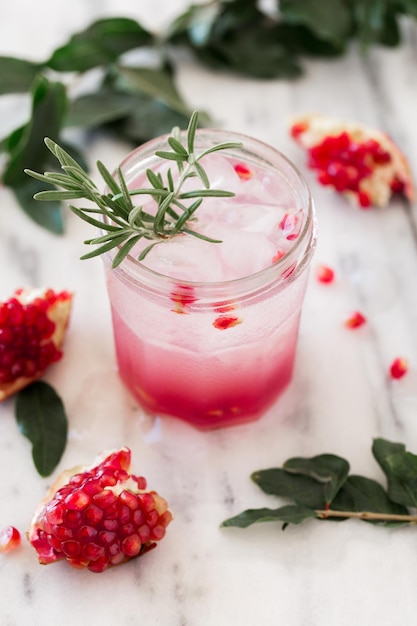 Cold homemade lemonade with pomegranate rosemary