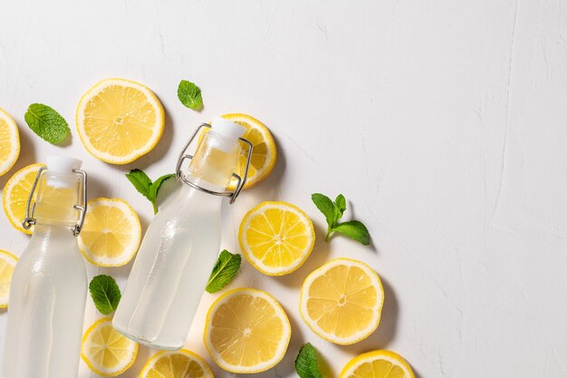 Cold lemon mint lemonade in glass bottles detox drink