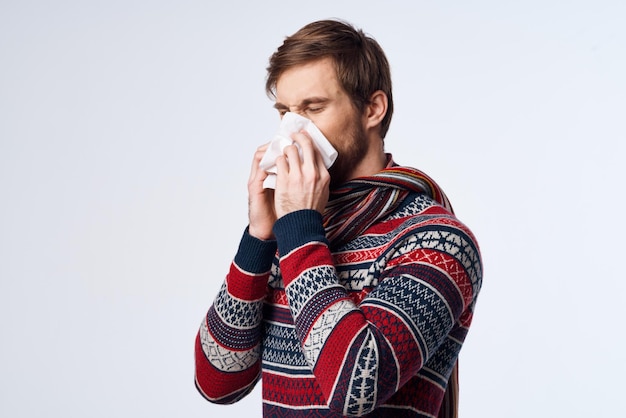 Cold man with a handkerchief health problem flu symptoms light background