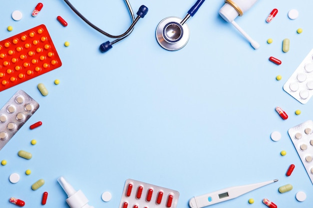 Cold medicine thermometer and phonendoscope on a blue background