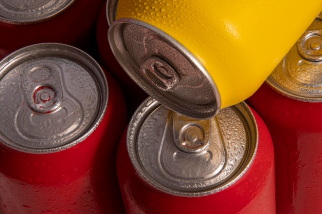 Cold red soda cans with a yellow one for conceptual use