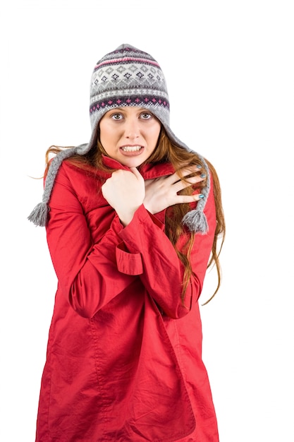 Cold redhead wearing coat and hat