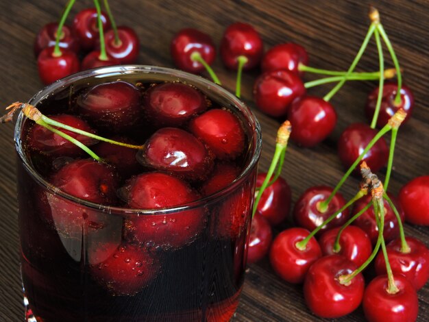 Cold refreshing cherry cola with fresh cherries.