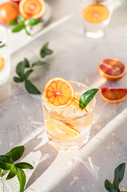 Cold refreshing drink with tonic blood Sicilian oranges and ice Direct sunlight and hard shadows