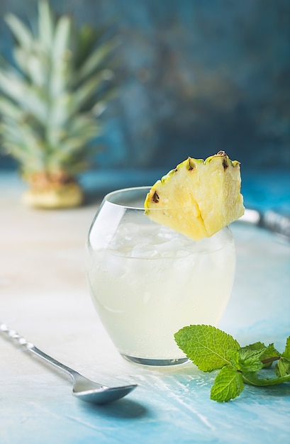 Cold refreshing pineapple drink with ice for hot summer day