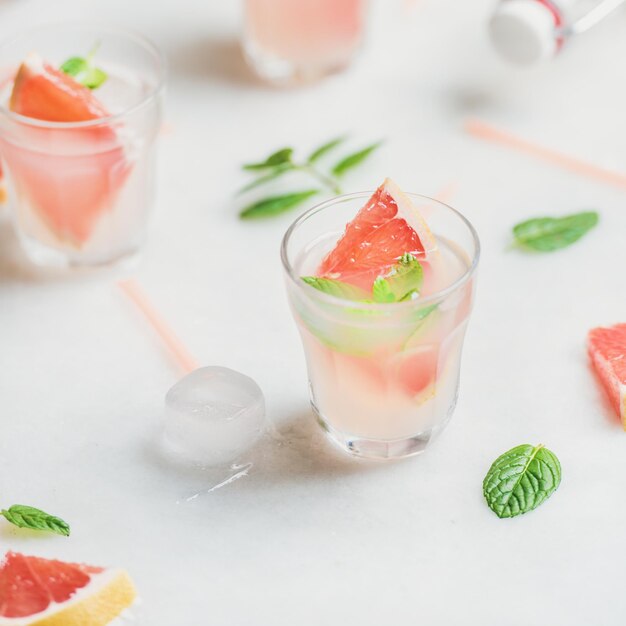 Cold refreshing summer alcohol cocktail with fresh grapefruit and ice