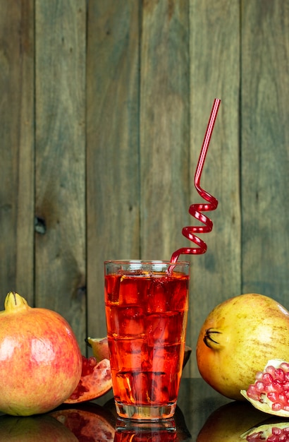 Cold ruby juice in glass and straw 