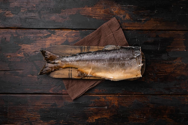 Cold smoked fish trout or salmon set, on old dark  wooden table background, top view flat lay, with copy space for text