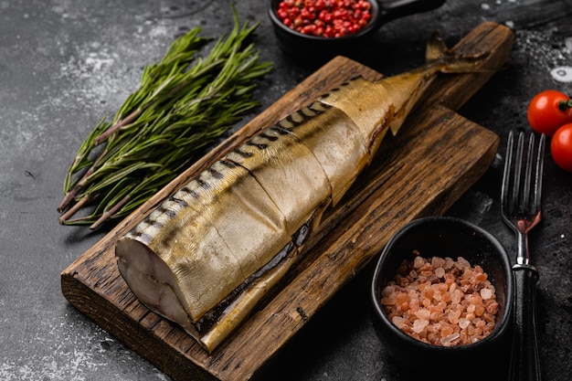 Cold smoked mackerel fish set, on black dark stone table background