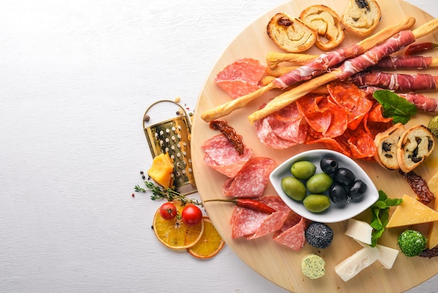 Cold snacks Chopped sausage bacon olives olives Top view Wooden background Free space for text